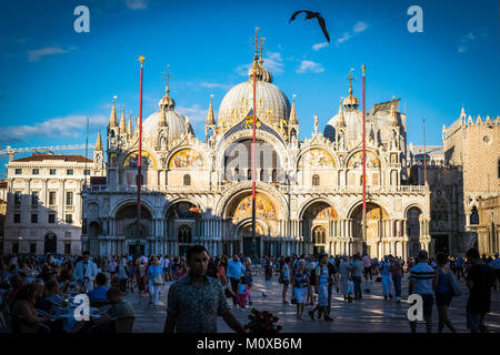 VENICE, ITALY, JULY 2 - Tourists at St Mark’s Square, with the Byzantine Saint Mark’s Basilica in background, on  2 JULY, 2017, Venice, Italy. Stock Photo