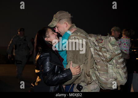 Staff Sgt. Justin Stevenson, 436th Security Forces Squadron defender, kisses his wife, Jamielee, while hugging his daughter, Julia, upon his return home from deployment to the Middle East Jan. 21, 2018, at Dover Air Force Base, Del. Stevenson’s team has been deployed since July 2017. (U.S. Air Force Stock Photo