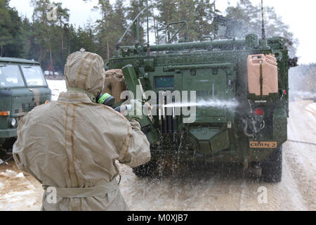 A Polish Soldier decontaminates a Stryker armored combat vehicle from 82nd Engineer Battalion, 2nd Armored Brigade Combat Team, 1st Infantry Division, at the vehicle decontamination site as the unit practices chemical, biological, radiological, nuclear and explosive response operations in preparation for Allied Spirit VIII Jan. 22, 2018 in Hohenfels, Germany. Allied Spirit VIII is designed to provide multinational interoperability training at brigade and battalion levels to enhance U.S. and NATO effectiveness.  (U.S. Army Stock Photo