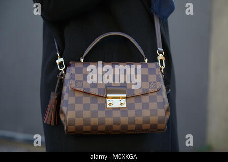MILAN, ITALY - SEPTEMBER 20, 2019: Woman with brown Louis Vuitton checkered  bag, white dress and Dior bracelets before Sportmax fashion show, Milan Fa  Stock Photo - Alamy