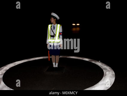 North Korean female traffic security officer in the night, Pyongan Province, Pyongyang, North Korea Stock Photo