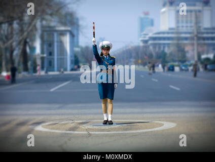 North Korean traffic security officer in blue uniform in the street, Pyongan Province, Pyongyang, North Korea Stock Photo