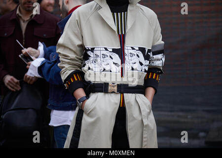MILAN - JANUARY 13: Man with beige trench coat with comics decoration before Neil Barrett fashion show, Milan Fashion Week street style on January 13, Stock Photo