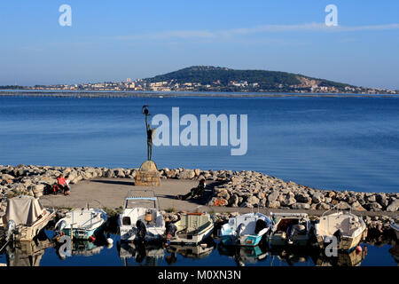 The fishing port of Meze, boats, sculpture in the background the Mont St Clair of Sete, Pond of Thau, Occitanie France