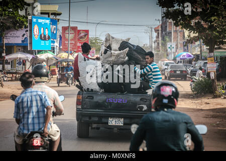 Workers riding in back of small lorry on road, Sangkat Kouk Chat, Krong Siem Reap, Cambodia.kat Kouk Chat, Krong Siem Reap, Cambodia. Stock Photo