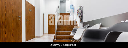 Panoramic view of clinic interior with black and white chairs and stairs Stock Photo