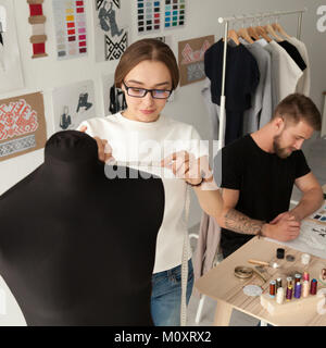 Creative fashion designers team working in clothes design studio Stock Photo