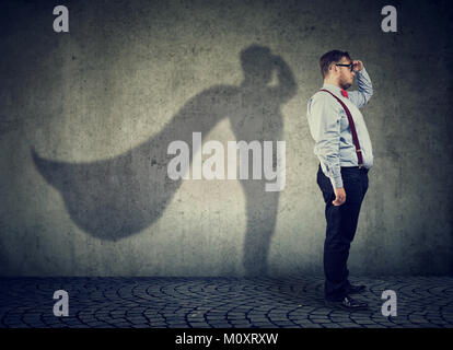 Side view of a chubby man imagining to be super hero looking aspired. Stock Photo