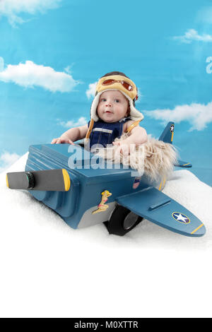 5 month old boy in toy aircraft, role play pilot Stock Photo