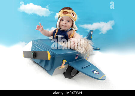 5 month old boy in toy aircraft, role play pilot Stock Photo