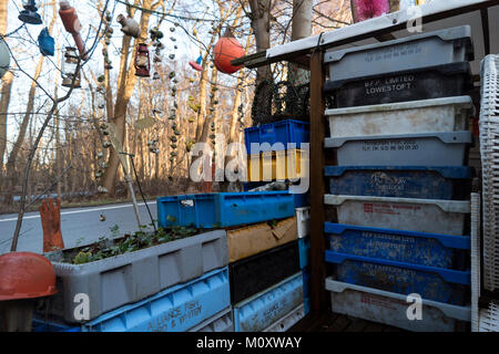 AMRUM, GERMANY - JANUARY 02, 2018: Fishing crates, buoys and other maritime objects in front of the old bar Blaue Maus on the North Frisian island Amr Stock Photo