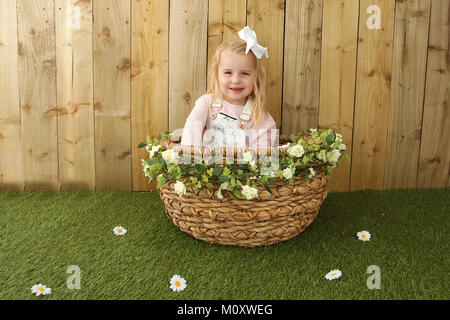 pretty 3 year old girl playing in the garden Stock Photo