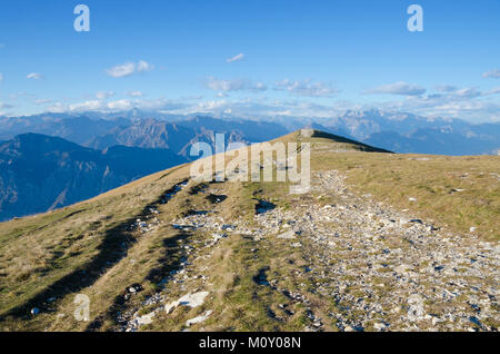 The mountain path leading from the top cable car station at Monte Baldo finishes at a vantage point that offers stunning views out across the northern Stock Photo