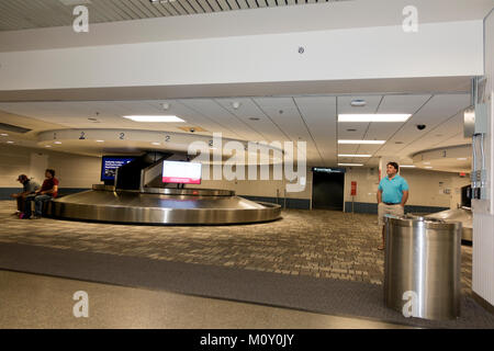 Minneapolis St Paul International Airport. People waiting for arrivals in the area of an empty baggage carousel. Minneapolis Minnesota MN USA Stock Photo