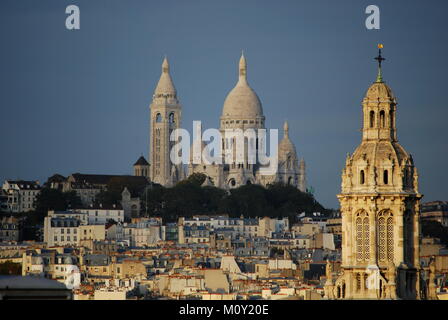 An amazing view of the Sacre Coeur with the Church of Saint Trinity in the foreground Stock Photo