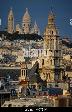 An amazing view of the Sacre Coeur with the Church of Saint Trinity in the foreground Stock Photo