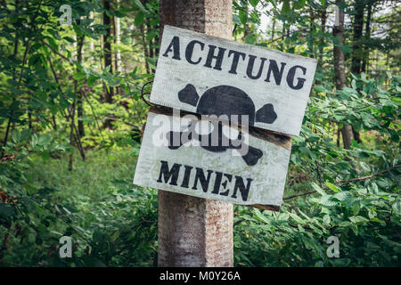 Warning mines sign in Mamerki (German: Mauerwald) bunker complex - former headquarters of Nazi Germany Land Forces High Command in Poland Stock Photo