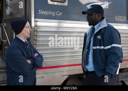 Two male Amtrak porter employees having a conversation while at a station break in Florida. Stock Photo