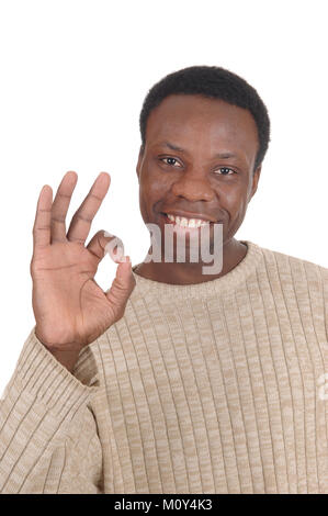 A young African American man in a beige sweater with one hand sign it is OK, isolated for white background Stock Photo
