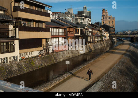 26.12.2017, Kyoto, Japan, Asia - A man is seen strolling down a pathway along the Kamo River in Kyoto at dawn. Stock Photo