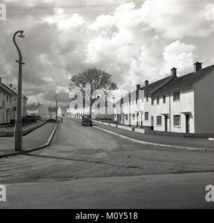 1950s, historical, new social housing....a solitary car parked on an empty road at a modern housing development built at Dungannon, Co Tyrone, Northern Ireland. Stock Photo