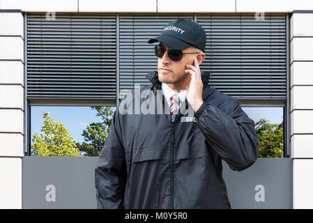 Portrait Of Security Guard Wearing Cap And Sunglasses Stock Photo