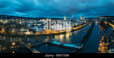 Aerial panoramic view of Zurich skyline at dawn, in the foreground the Limmat river. Stock Photo