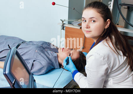 Ophthalmologist performs an operation to diagnose the eyesight of a young girl. Stock Photo