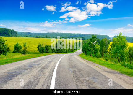Rural paved road among green fields Stock Photo - Alamy