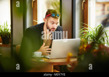 Surprised man at laptop Stock Photo