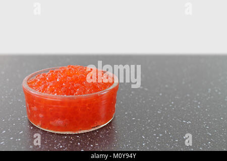 Glass bowl with red salmon caviar. Traditional russian food. Stock Photo