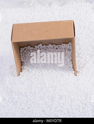 Box on little  white polystyrene foam balls Stock Photo