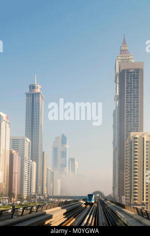 Dubai metro with skyscrapers on either side Stock Photo