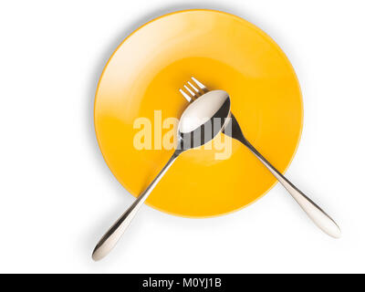 Fork and spoon on empty yellow plate top view. Isolated on white with copy space, clipping path included Stock Photo