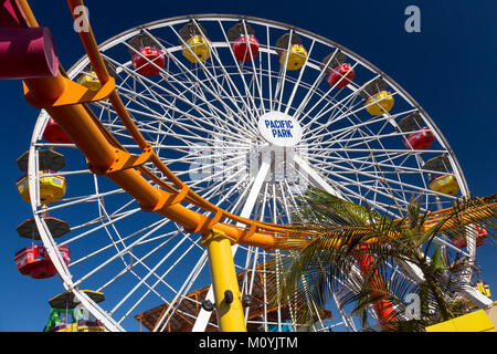 Roller coaster and Ferris wheel at Pacific Amusement Park, Santa Monica Pier, California Stock Photo