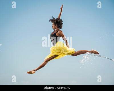 Water spraying on black woman ballet dancing Stock Photo