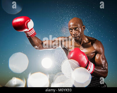 Water splashing on black boxer outdoors Stock Photo