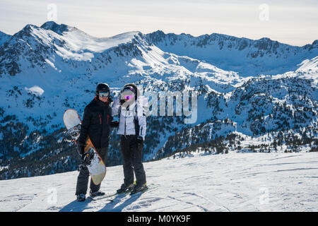 A couple pose for a portrait at the top of a run in Grau Roig, Grandvalaria ski area, Andorra, Europe Stock Photo