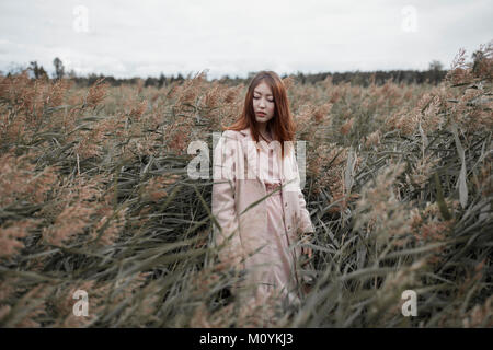 Asian woman standing in field Stock Photo