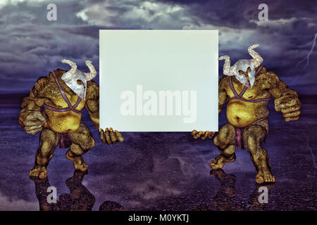 Green ogres holding blank sign Stock Photo