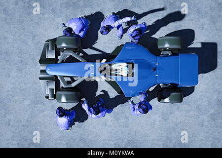 Futuristic pit crew servicing race car Stock Photo
