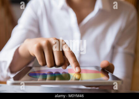 Finger of African American woman using digital tablet Stock Photo