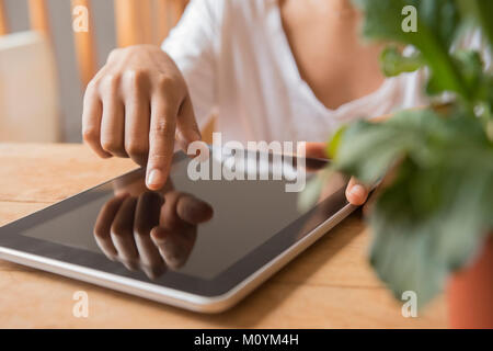 Hands of African American woman using digital tablet Stock Photo