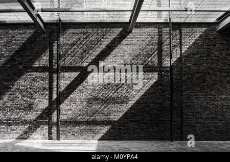 Sunlight pass through the net and reflecting on the brick wall and floor. Stock Photo