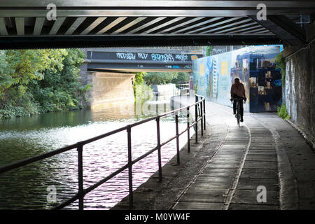 Cyclist along the Regents canal and bridges near Camden. Stock Photo