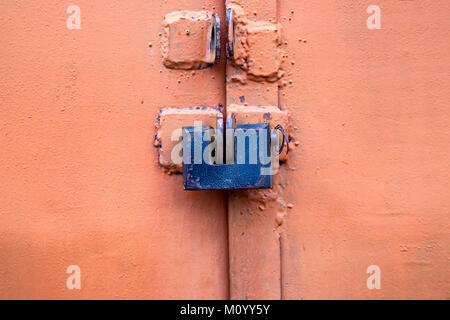 Old metal lock on pink garage door close Stock Photo