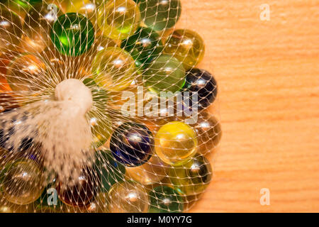 Colorful glass marbles in net Stock Photo