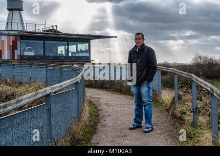 Essex UK. Man outside Visitor Centre of Rainham Marshes RSPB nature reserve next to Thames Estuary in Purfleet, Large wetland Bird sanctuary Stock Photo