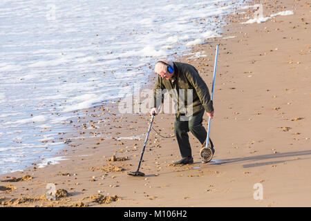 Bournemouth, Dorset, UK. 25th Jan, 2018.  Treasure hunter combs along the seashore hoping to find buried treasure at Bournemouth beach on a warm sunny day. Credit: Carolyn Jenkins/Alamy Live News Stock Photo