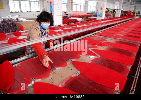 Hefei, China's Anhui Province. 24th Jan, 2018. Workers make lanterns at a factory in Luyang District of Hefei City, east China's Anhui Province, Jan. 24, 2018. People here work hard to make red lanterns for Chinese Lunar New Year. Credit: Zhang Duan/Xinhua/Alamy Live News Stock Photo